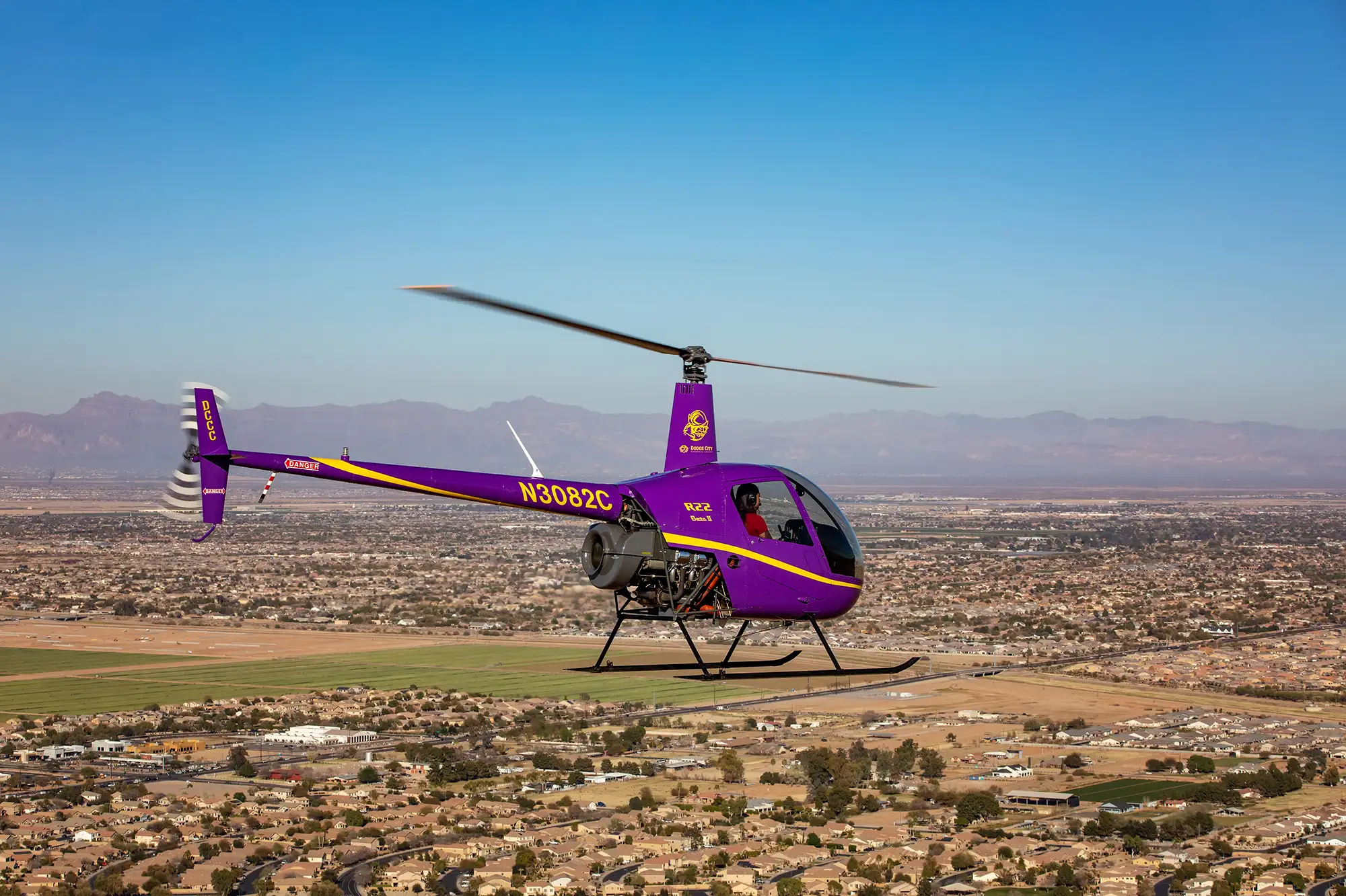 helicopter flying over desert city
