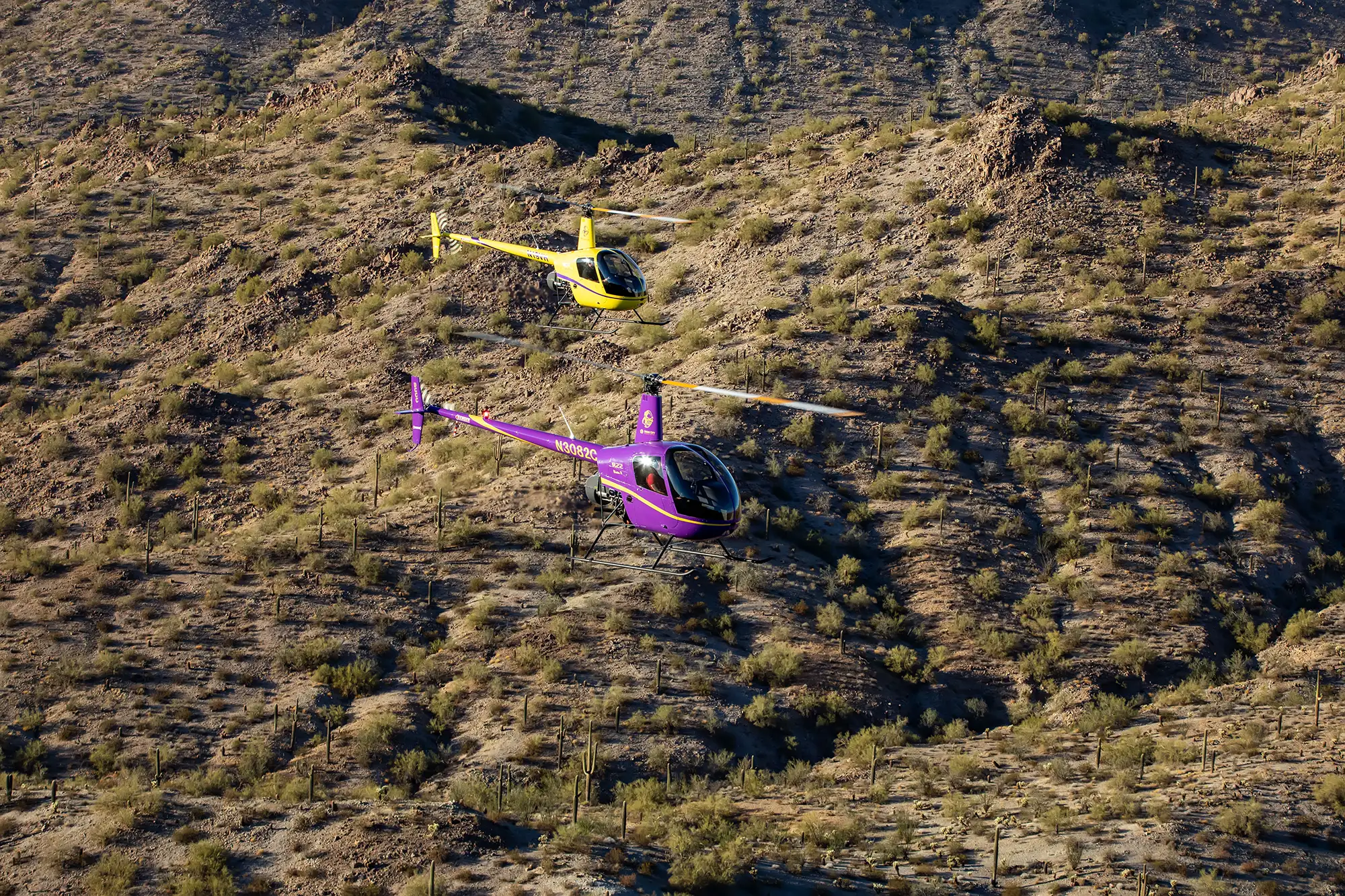 helicopters flying over desert