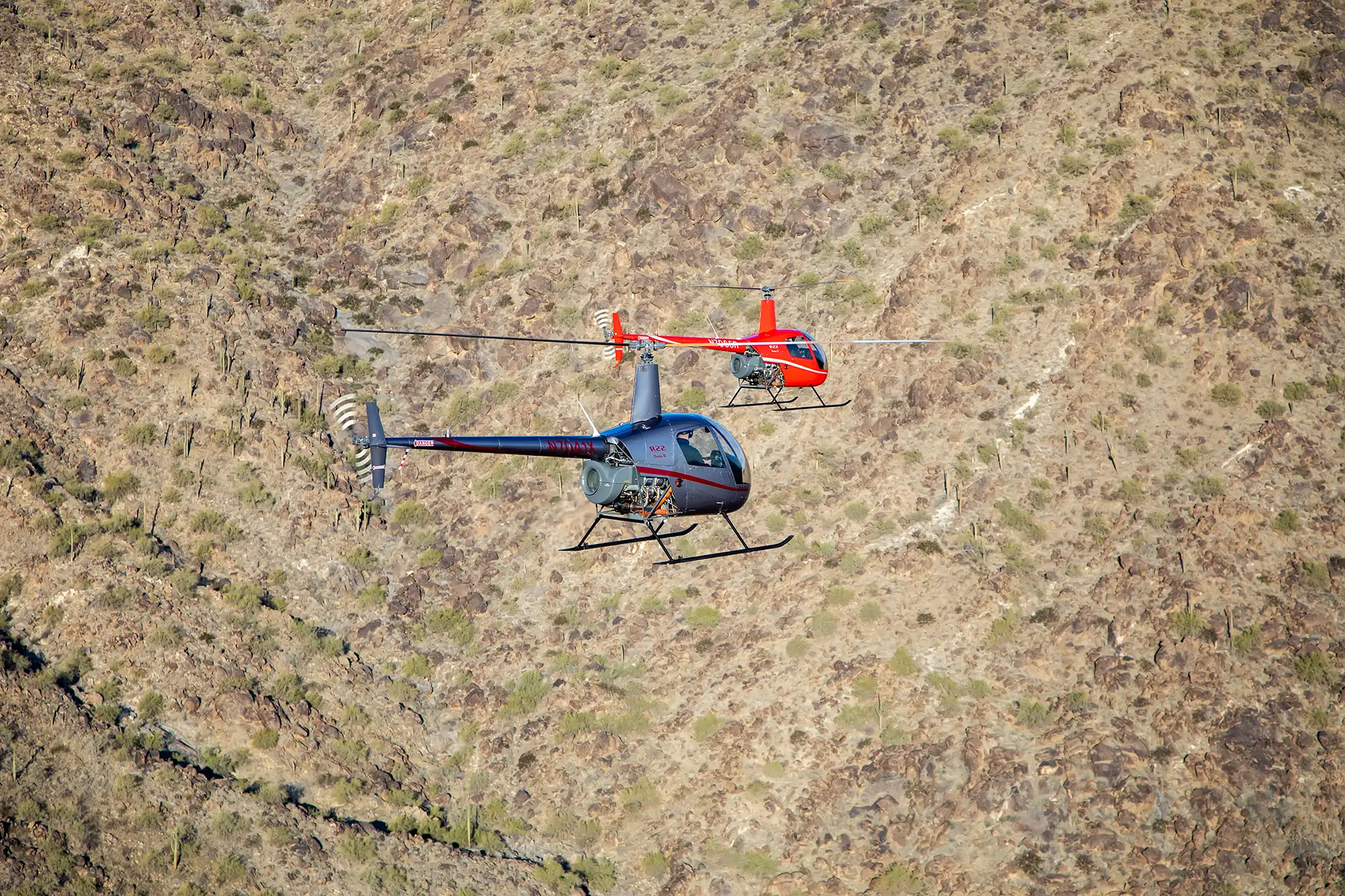 helicopters flying over desert