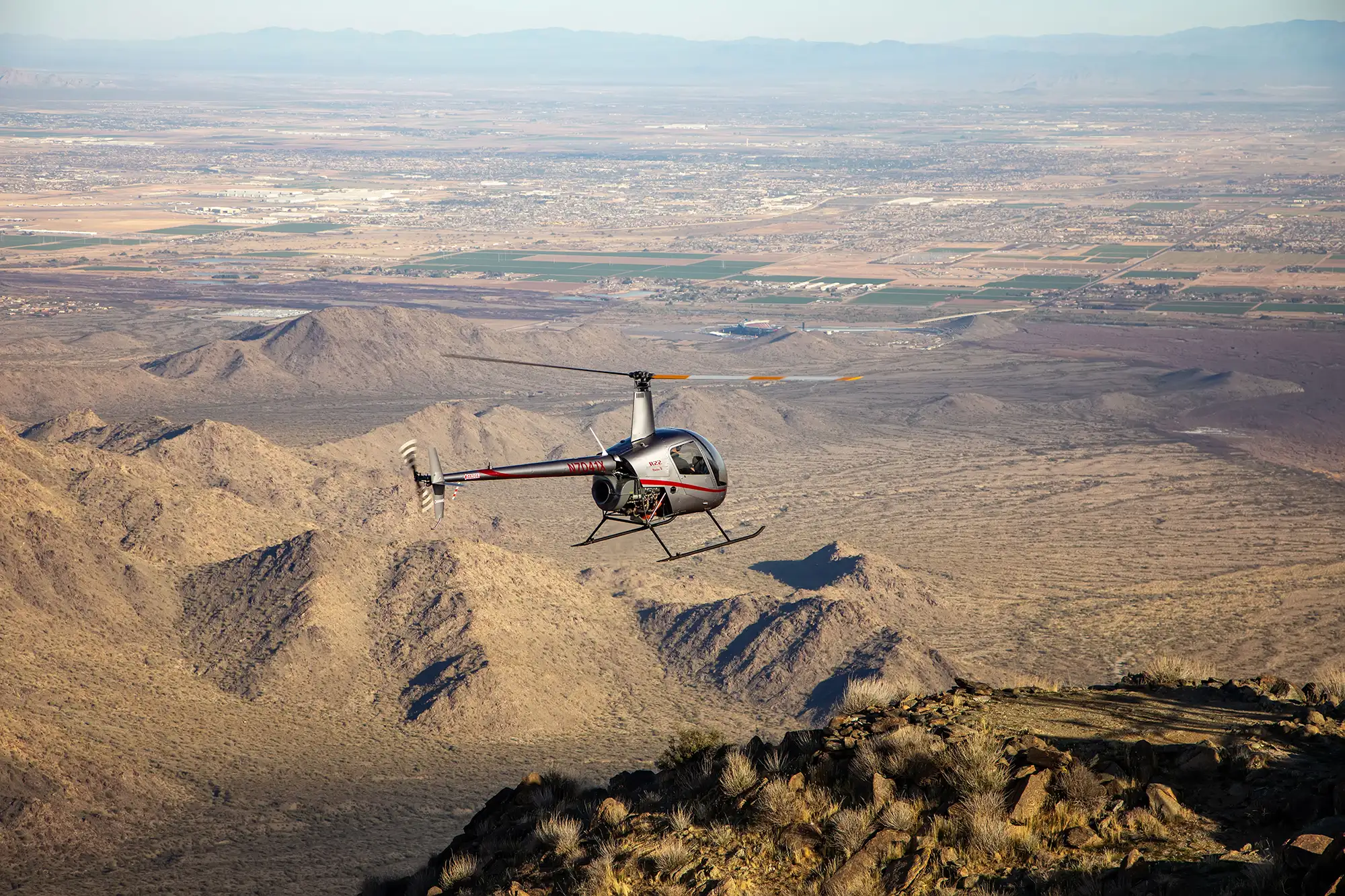 helicopter flying over desert