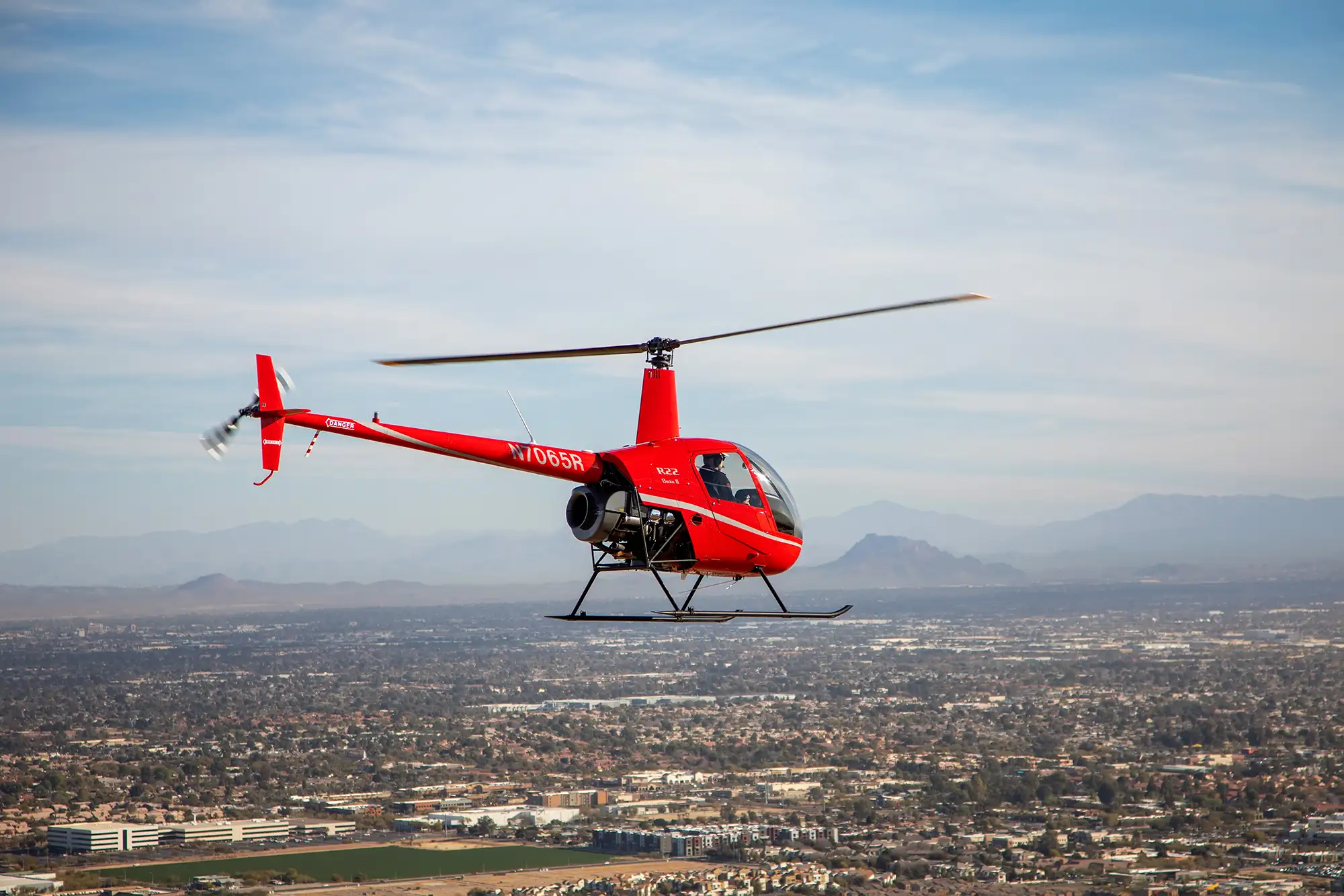 Aerial photography of helicopter flying over city