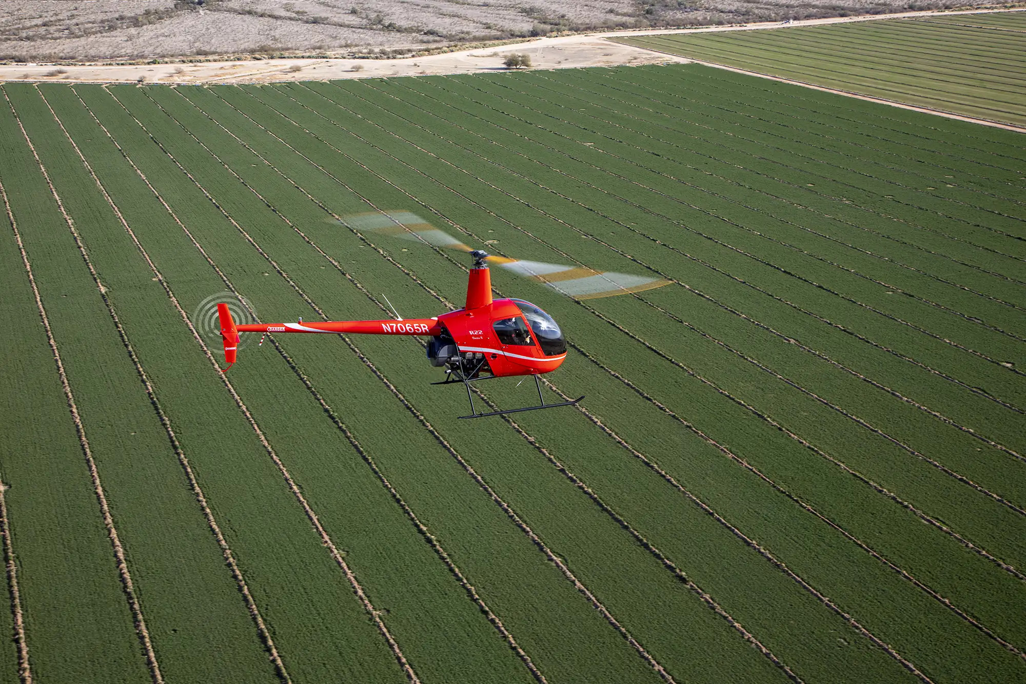 Aerial photography of helicopter flying over fields