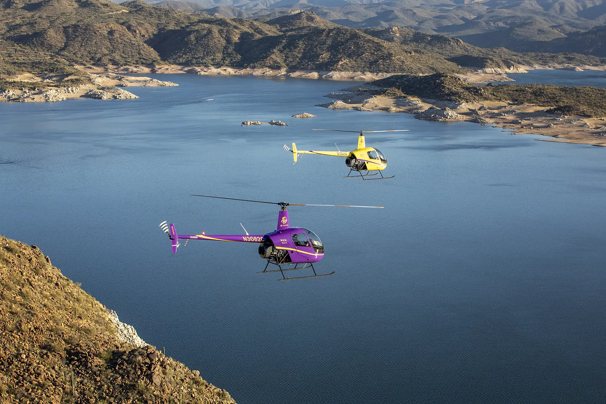 Aerial photography of helicopters flying over lake