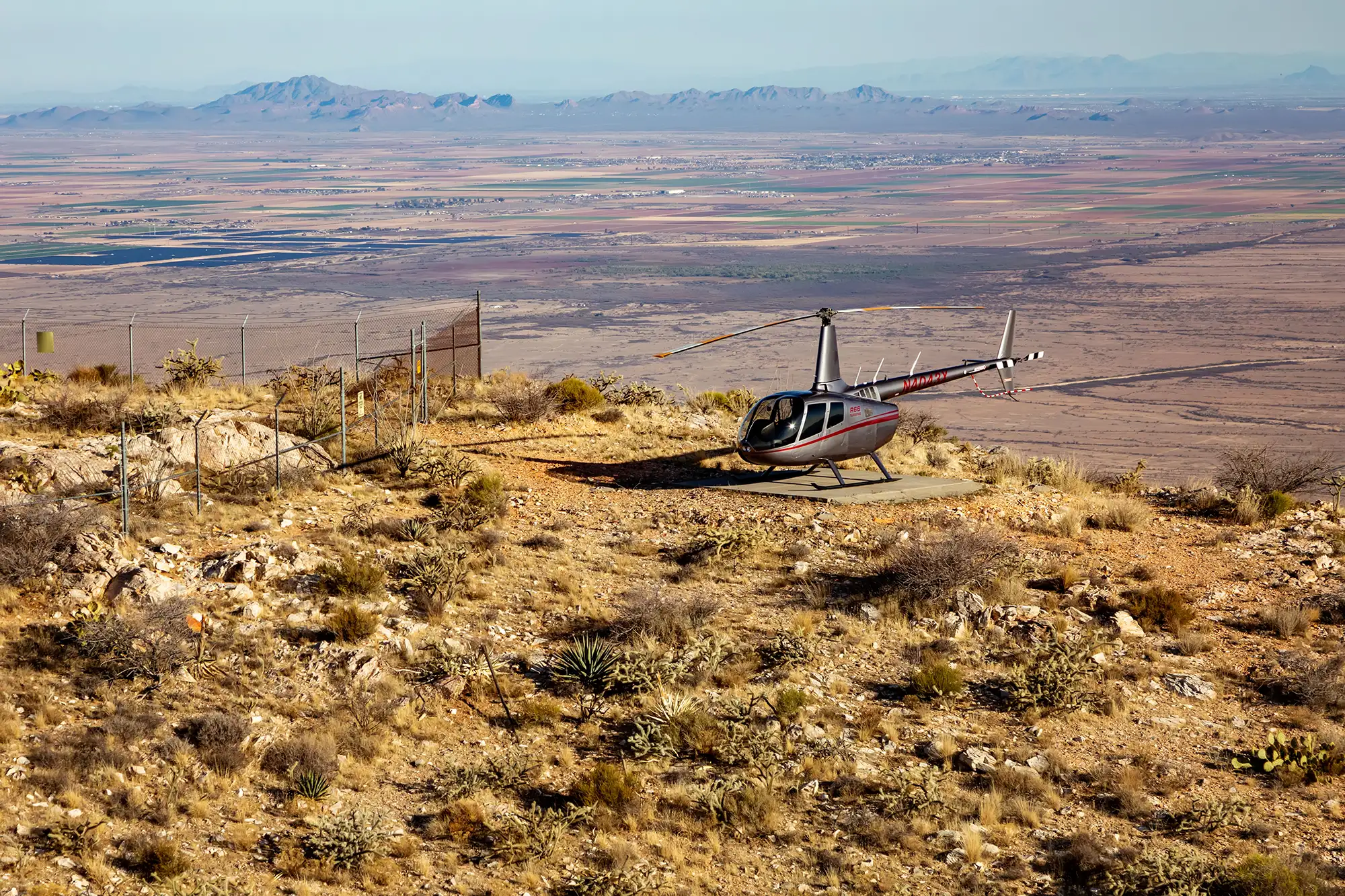 helicopter on landing pad atop a mountain