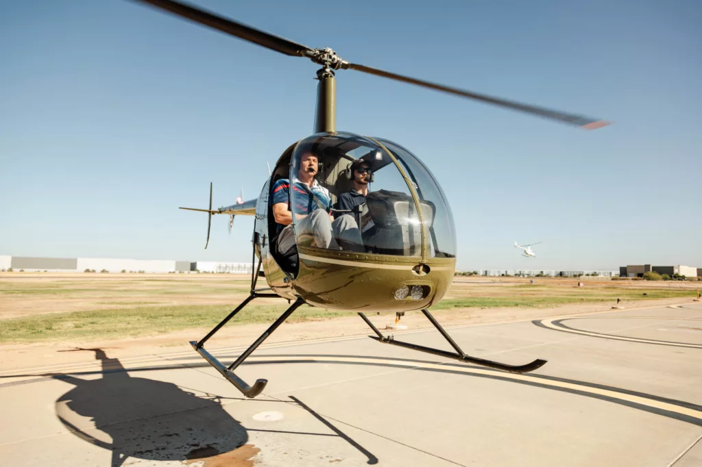 Helicopter taking off with student pilot