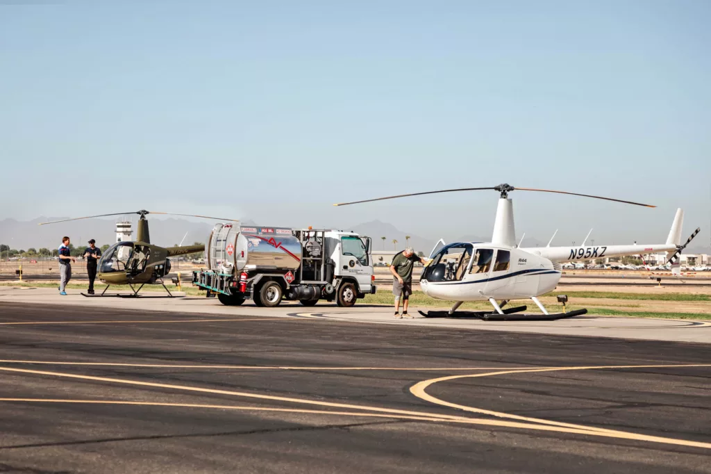 Air field with helicopter and service vehicle