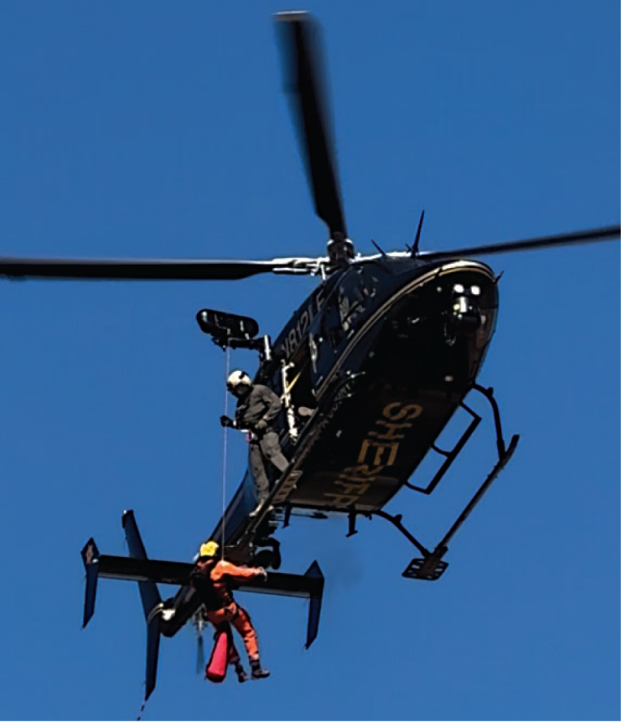 Photo of person repelling from chopper